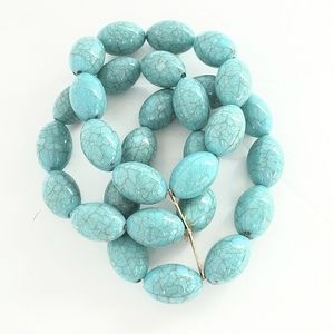 Triple Strand Turquoise colored egg shaped beads on a stretch bracelet w/ bar